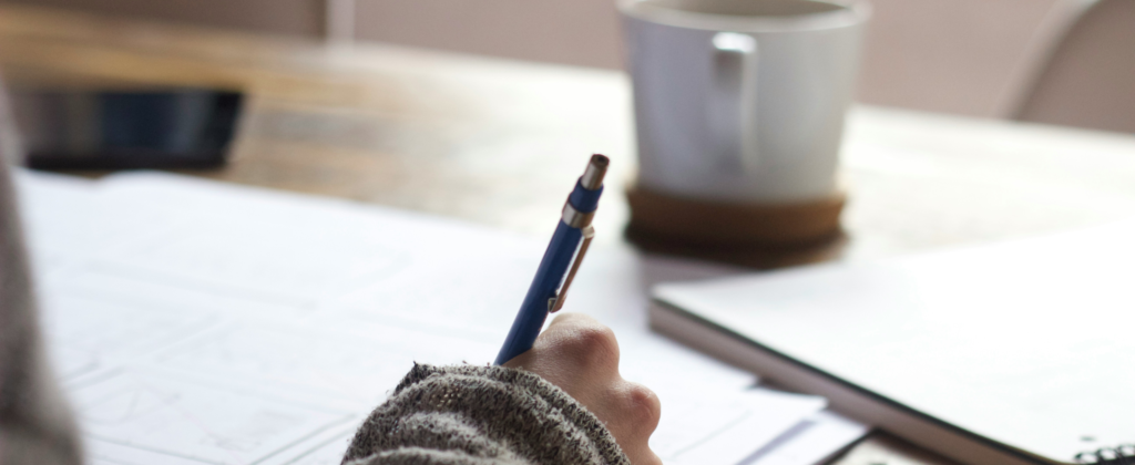 hand holding pen and writing