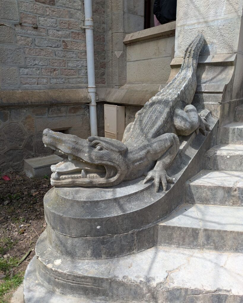 Crocodile sculpture guarding an entrance at Château d'Abbadia