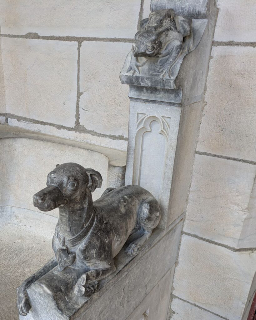 Greyhound and toad sculptures guarding an entrance at Château d'Abbadia